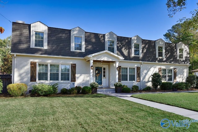 3318 Ohara Rd SW, Huntsville, AL 35801 - new england style home featuring mansard roof, a front yard, a shingled roof, and brick siding