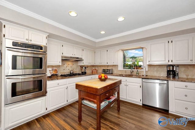 kitchen with white cabinets and appliances with stainless steel finishes