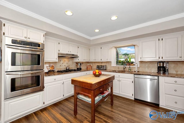 3318 Ohara Rd SW, Huntsville, AL 35801 - kitchen featuring dark stone counters, recessed lighting, a sink, stainless steel appliances, and white cabinetry