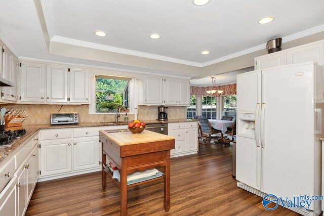 kitchen featuring appliances with stainless steel finishes, dark wood-type flooring, a healthy amount of sunlight, and white cabinetry