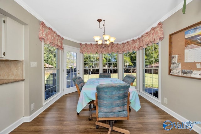 dining room featuring ornamental molding, an inviting chandelier, and dark hardwood / wood-style flooring