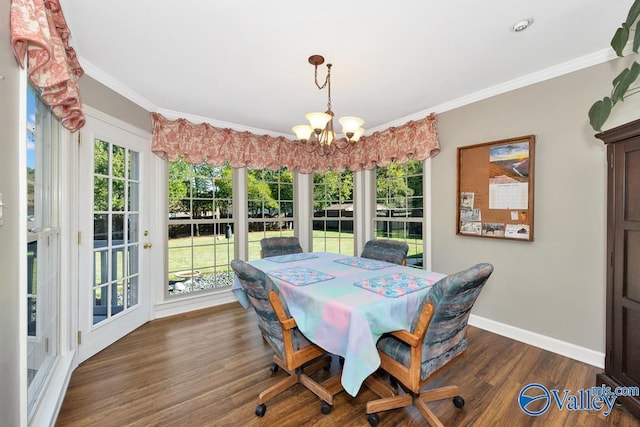 3318 Ohara Rd SW, Huntsville, AL 35801 - dining space featuring baseboards, ornamental molding, an inviting chandelier, and dark wood-style flooring