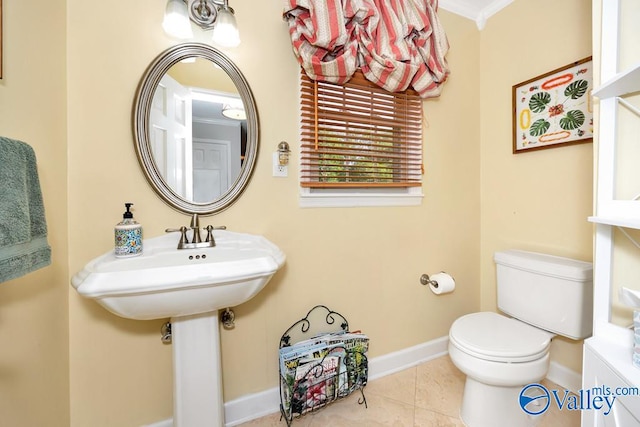 bathroom featuring ornamental molding, tile patterned floors, and toilet