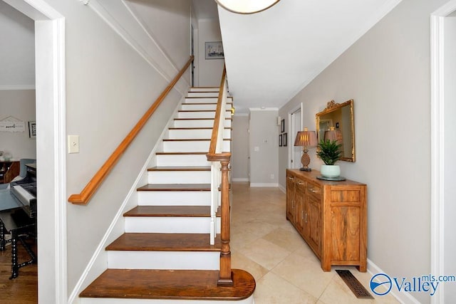3318 Ohara Rd SW, Huntsville, AL 35801 - staircase featuring tile patterned floors, visible vents, crown molding, and baseboards