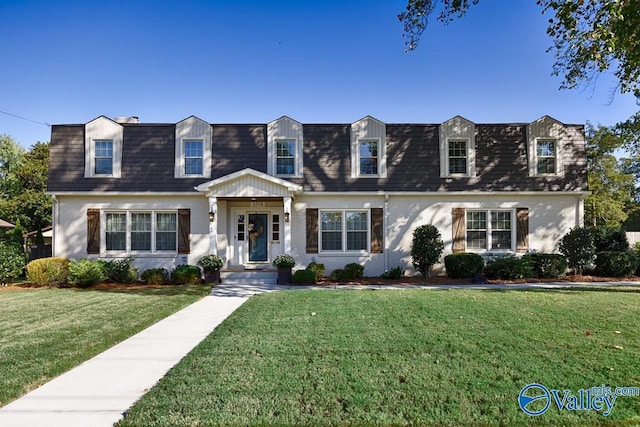 3318 Ohara Rd SW, Huntsville, AL 35801 - cape cod-style house with a front lawn, a shingled roof, brick siding, and mansard roof