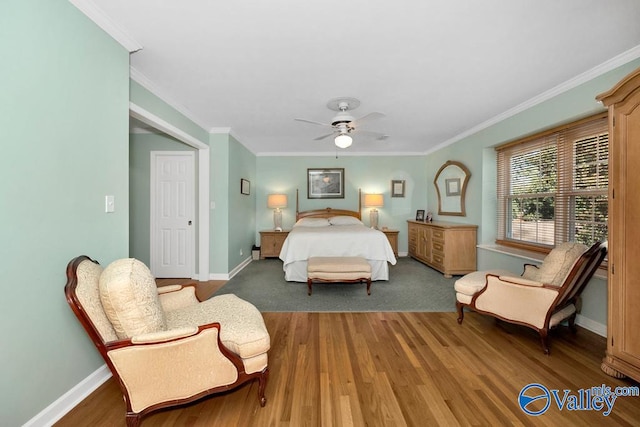 bedroom featuring ornamental molding, ceiling fan, and dark hardwood / wood-style flooring