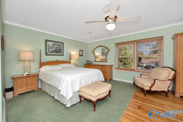 bedroom with wood-type flooring, crown molding, and ceiling fan