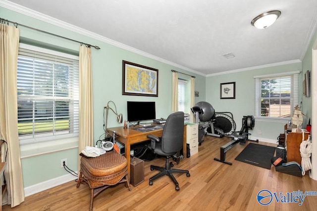 home office with light hardwood / wood-style flooring and crown molding