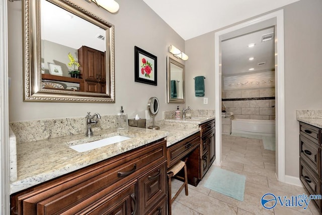 3318 Ohara Rd SW, Huntsville, AL 35801 - bathroom with tile patterned flooring, visible vents, a washtub, and vanity