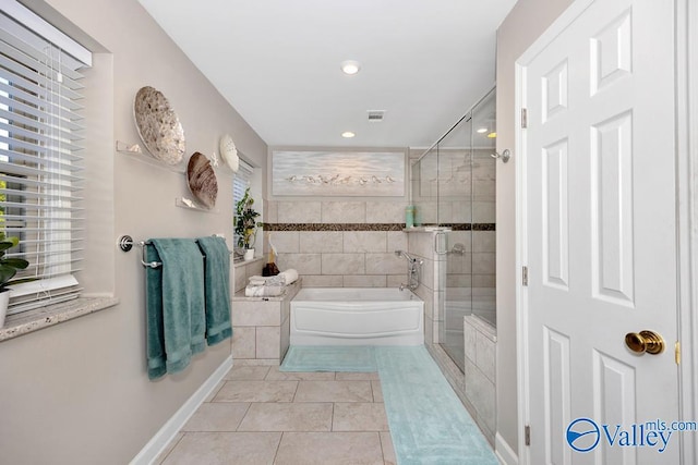 bathroom with tile patterned floors and independent shower and bath