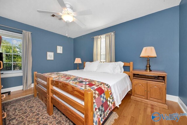 3318 Ohara Rd SW, Huntsville, AL 35801 - bedroom with baseboards, visible vents, ceiling fan, and light wood-style flooring