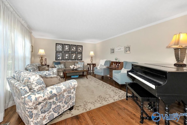 living room with hardwood / wood-style flooring and crown molding