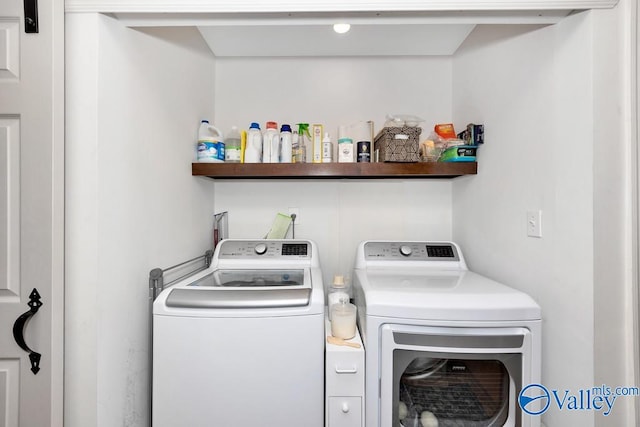 clothes washing area with washing machine and dryer