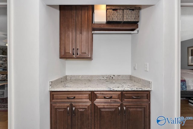 3318 Ohara Rd SW, Huntsville, AL 35801 - kitchen featuring wood finished floors, light stone countertops, and dark brown cabinetry