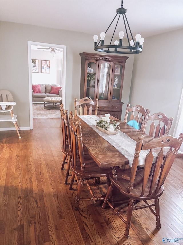 dining room featuring wood-type flooring and a chandelier