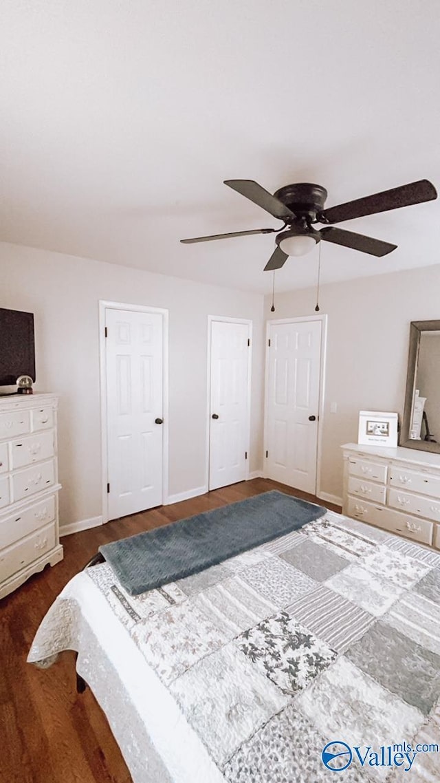 bedroom with ceiling fan and dark hardwood / wood-style flooring