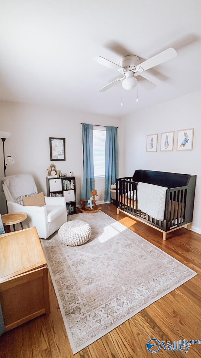 bedroom with ceiling fan and wood-type flooring