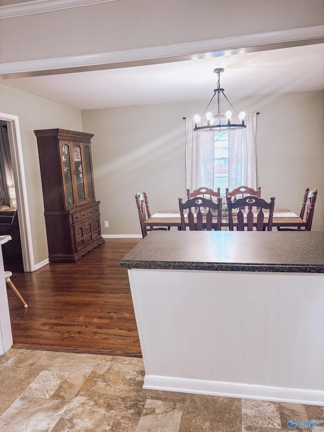 kitchen featuring hanging light fixtures, hardwood / wood-style flooring, dark brown cabinetry, and an inviting chandelier