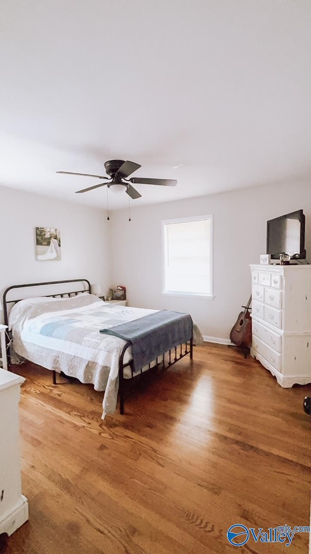 bedroom featuring ceiling fan and hardwood / wood-style floors