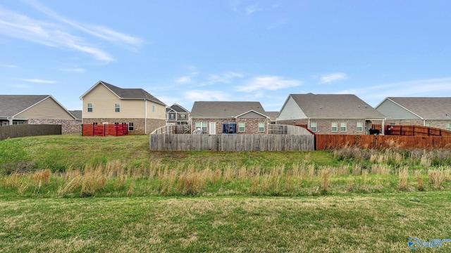 view of yard featuring fence and a residential view