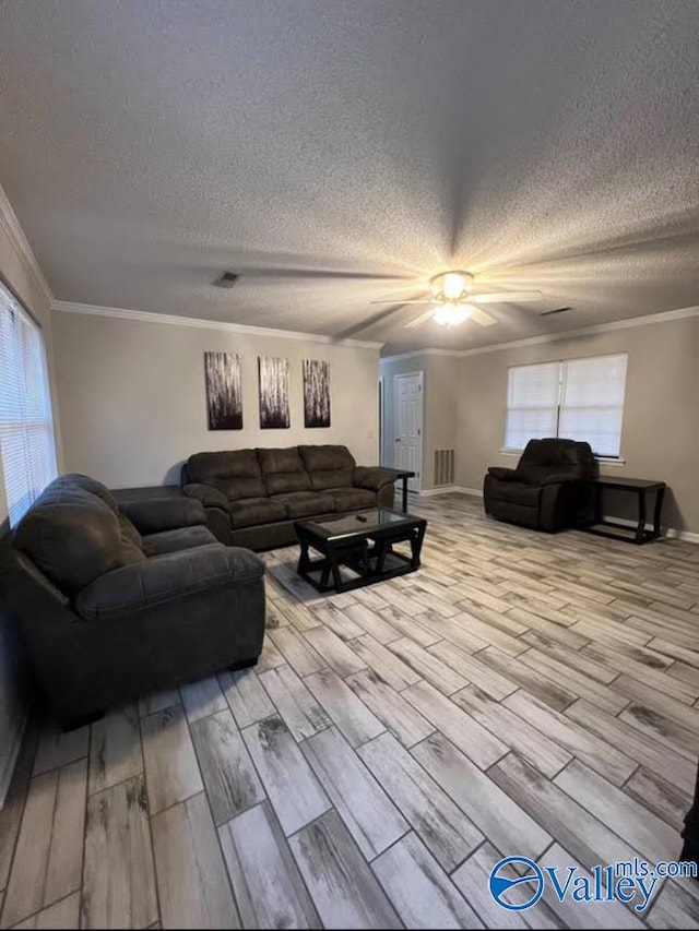 living room with a healthy amount of sunlight, ceiling fan, and light hardwood / wood-style floors