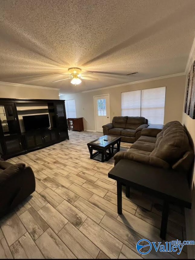 living room featuring light hardwood / wood-style flooring, ceiling fan, ornamental molding, and a fireplace