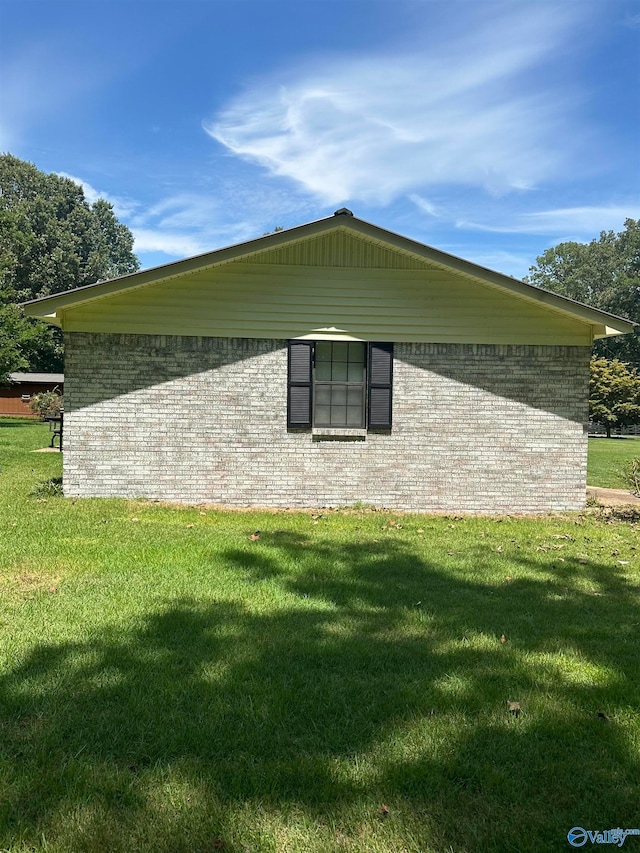 view of side of home with a lawn