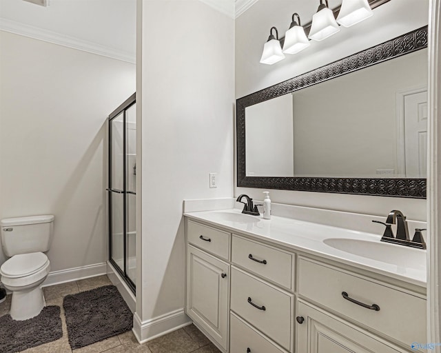 full bathroom featuring a stall shower, toilet, ornamental molding, and a sink