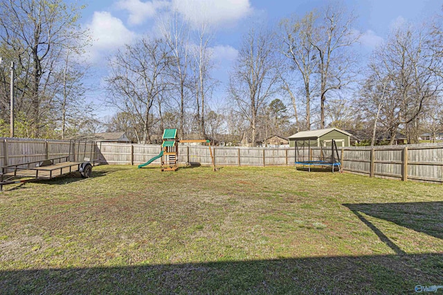 view of yard featuring a fenced backyard, a playground, and a trampoline