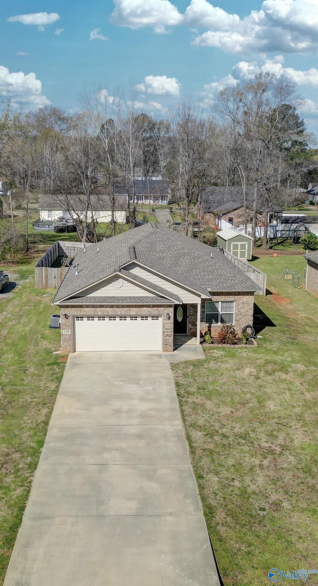 view of front facade with driveway, a front yard, and a garage