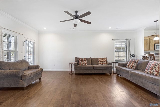 living area with dark wood-style flooring, ornamental molding, baseboards, and ceiling fan