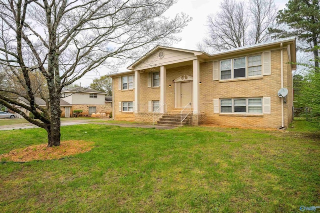 raised ranch featuring a front lawn