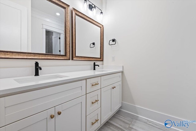 bathroom with dual bowl vanity and tile patterned flooring