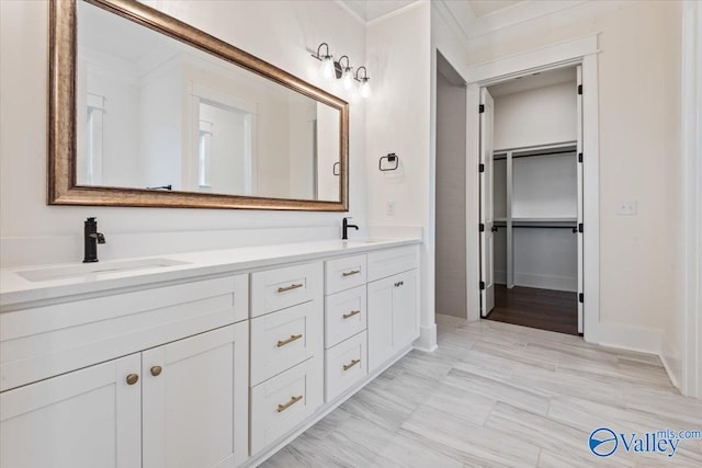 bathroom with dual vanity and wood-type flooring