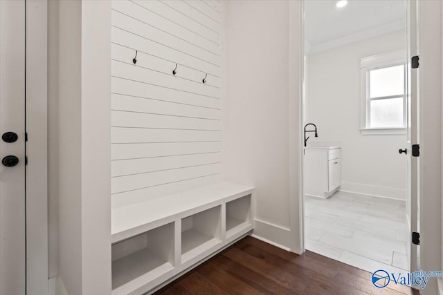 mudroom featuring hardwood / wood-style flooring and ornamental molding