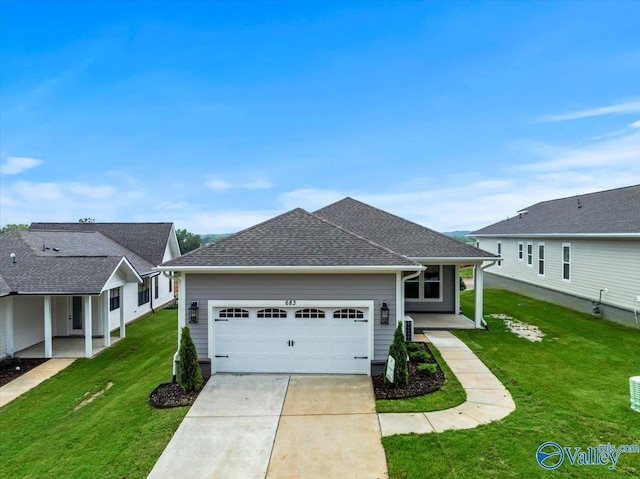 view of front of home featuring a garage and a front lawn