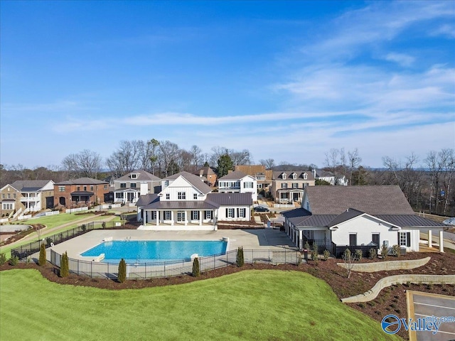 view of swimming pool with a yard