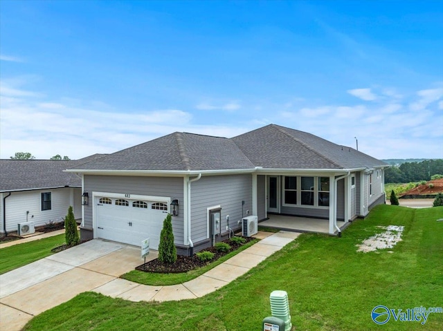 ranch-style house with a garage, a front lawn, and central AC