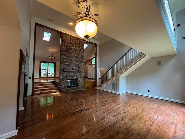 unfurnished living room with stairs, wood-type flooring, and a fireplace