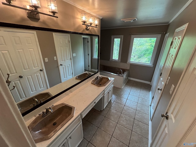 bathroom with a garden tub, double vanity, a sink, and tile patterned floors