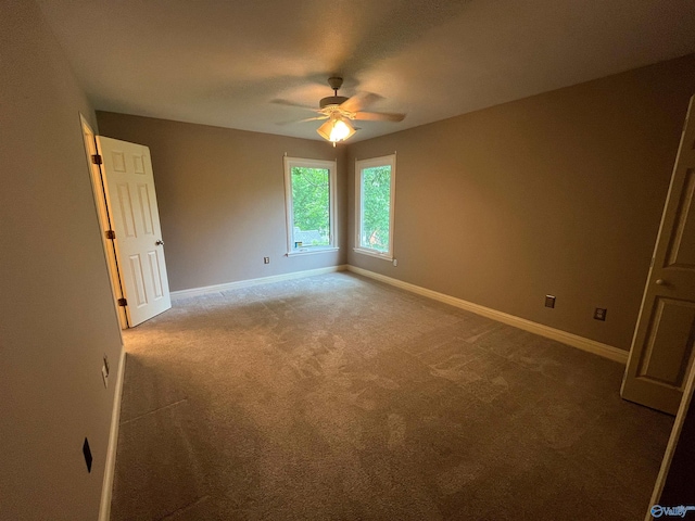 unfurnished room with carpet, baseboards, and ceiling fan