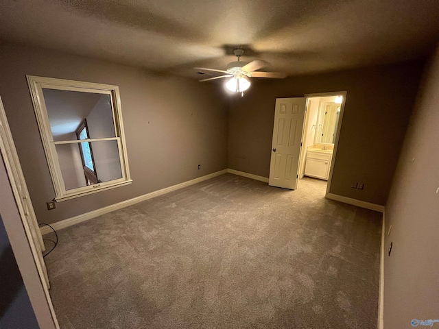 unfurnished bedroom with baseboards, a ceiling fan, ensuite bath, a textured ceiling, and carpet flooring