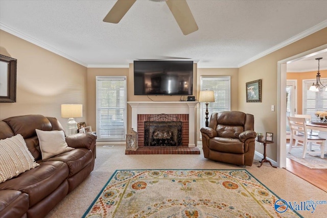 living area with a wealth of natural light, a textured ceiling, ceiling fan, and ornamental molding