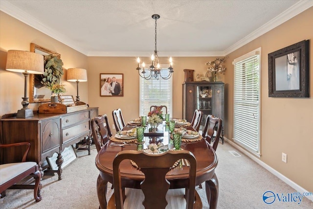 dining space featuring visible vents, crown molding, baseboards, carpet flooring, and a notable chandelier