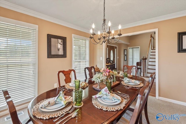 dining room featuring stairway, visible vents, an inviting chandelier, ornamental molding, and carpet flooring