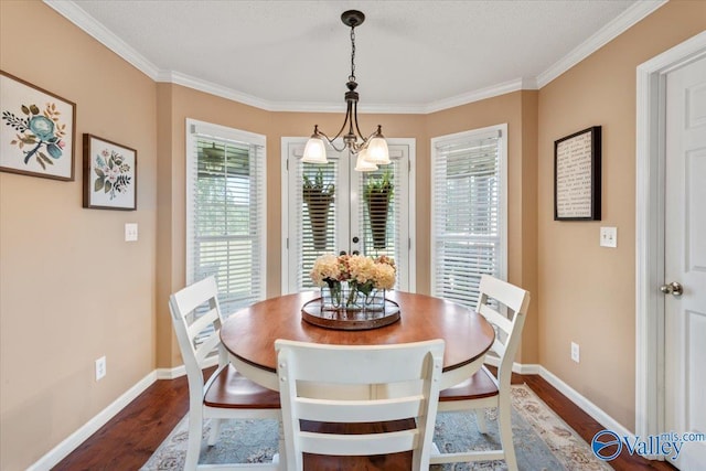 dining area featuring a chandelier, baseboards, dark wood finished floors, and ornamental molding