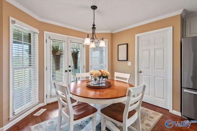 dining area featuring dark wood finished floors, french doors, visible vents, and ornamental molding