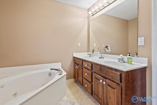 full bath featuring a sink, a jetted tub, baseboards, and double vanity