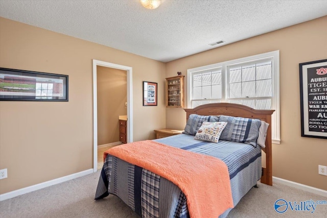 carpeted bedroom featuring visible vents, baseboards, and a textured ceiling