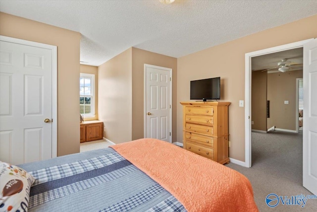 bedroom with baseboards, a textured ceiling, and carpet flooring